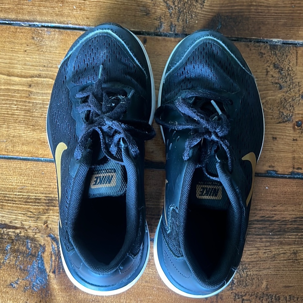 Black and gold Nike sneakers size 3Y.